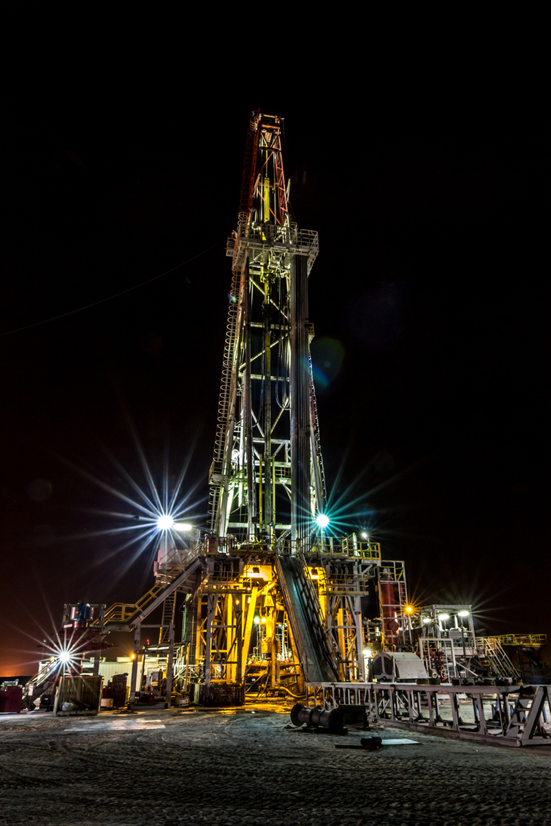 Natural gas drilling rig at night